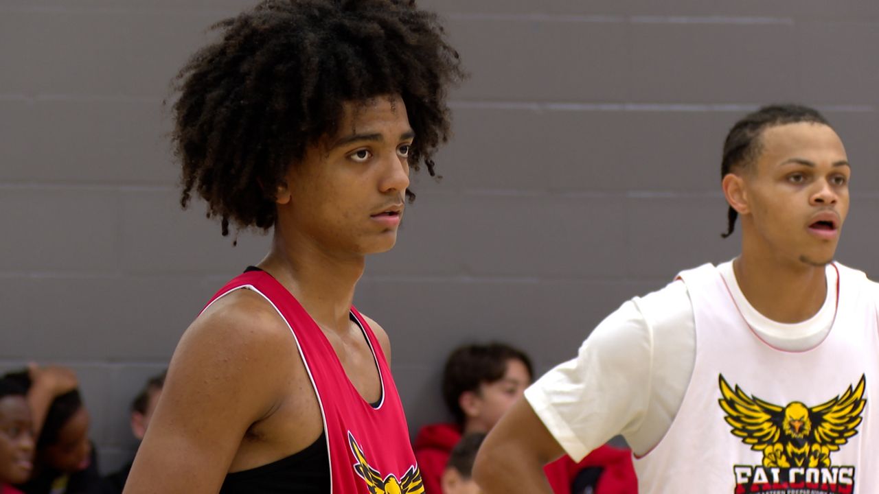 Beckham Black listening to his head coach and step-father David Peavy during practice for Southeastern Preparatory Academy.