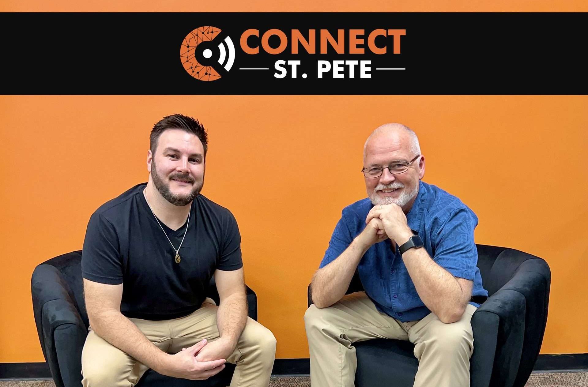 Two men sitting in leather chairs, in front of an orange wall that says Connect St. Pete.