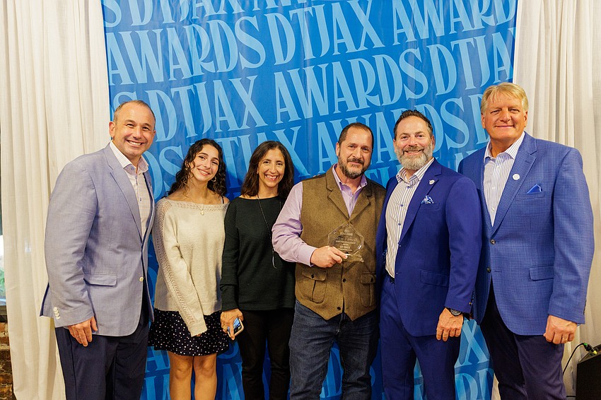 Downtown Achievement Award winner Guy Parola, director of operations for the Downtown Investment Authority, holds his award at the 11th annual DTJax Awards at The Lark in Downtown Jacksonville.
