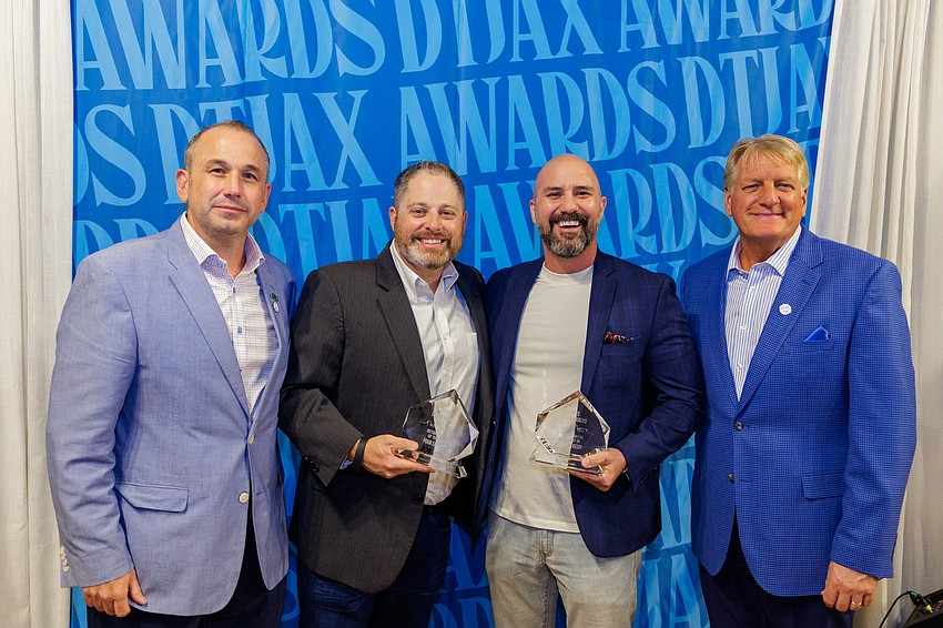 Pour Taproom and Pizza Dynamo in the VyStar Credit Union garage at 61 N. Laura St was named the Retail Project of the Year at the 11th annual DTJax Awards. From left, Downtown Vision Inc. CEO Jake Gordon, Pour Taproom owner Tony Draper, Pizza Dynamo owner Jeremy Gatto and DVI board chair Paul Davison.