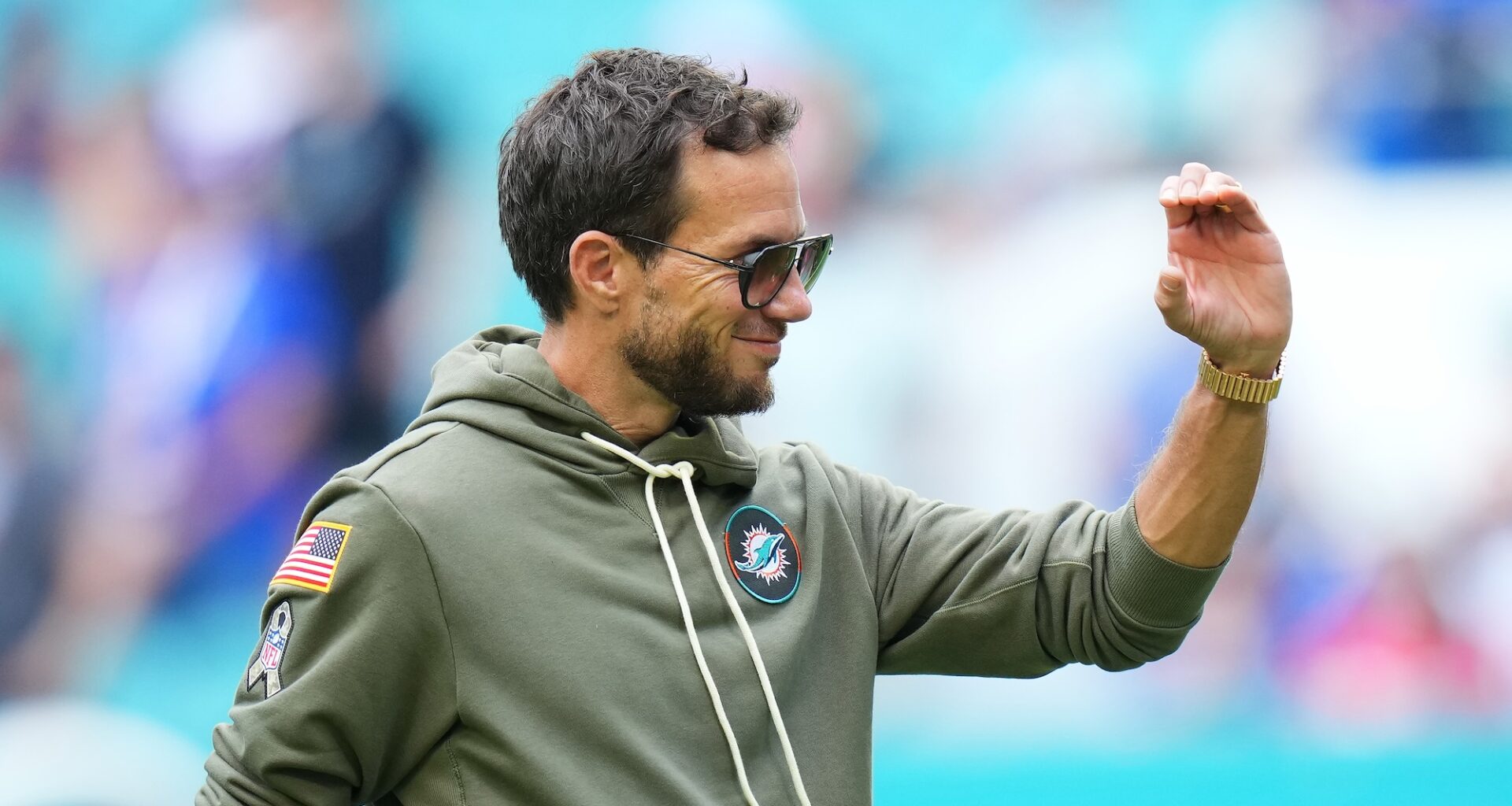 pregame shot of an NFL coach wearing a hoody and looking just a bit cocky