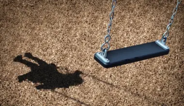 A child's shadow and an empty playground swing symbolize missing or endangered children.