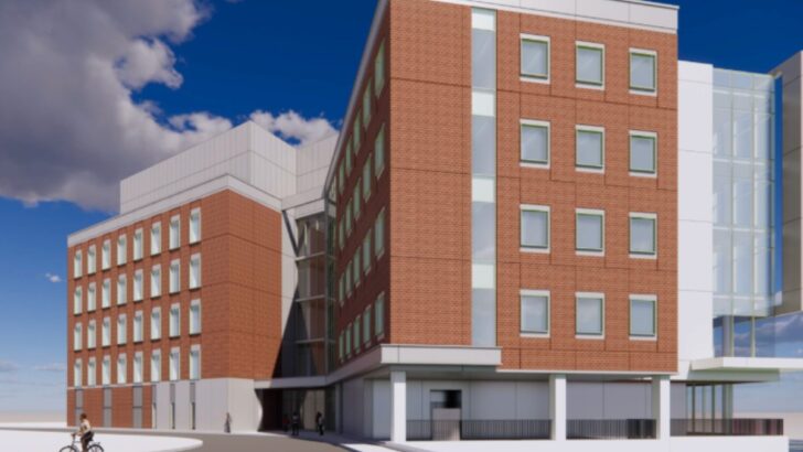 Front view of UTampa’s new science and research building with brick and glass.