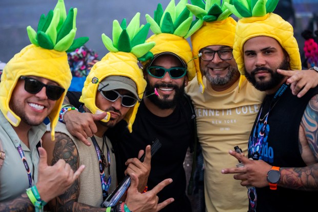 A group of festival attendees wear pineapple hats during EDC...