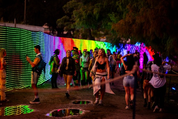 Festival attendees walk along Pixel Path during EDC Orlando at...