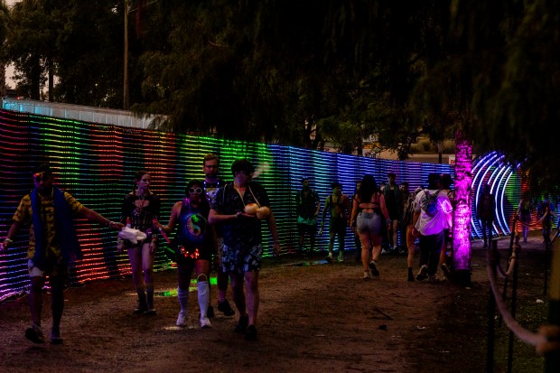 Festival attendees walk along Pixel Path during EDC Orlando at...
