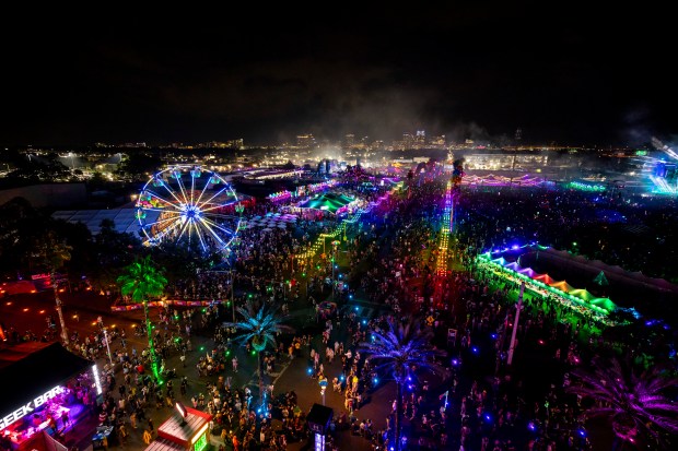 The Orlando skyline is seen in the background as festival-goers...