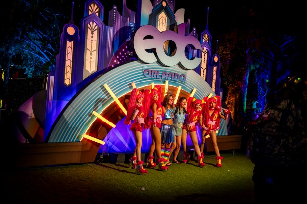 Festival attendees gather for a photo with street performers during...