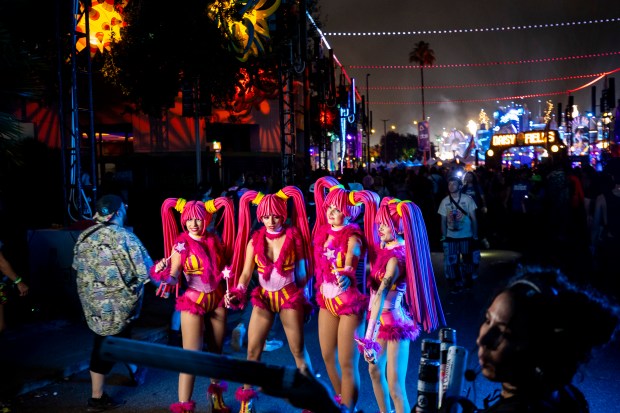 Street performers stand for a photo during EDC Orlando at...