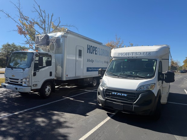 Two Hope Florida vehicles parked outside the Department of Children and Families headquarters in Tallahassee. State officials said they cannot find records for any Hope Florida vehicles. (Jeffrey Schweers/Orlando Sentinel)