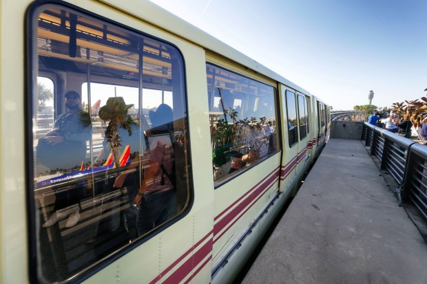 Passengers ride a 25-year-old Bombardier CX-100 tram into Airside 2...