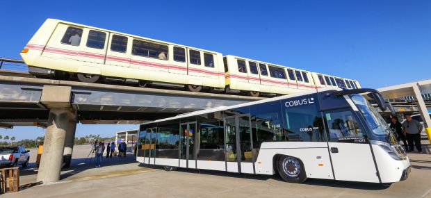 A 25-year-old Bombardier CX-100 tram passes over a new Cobus...