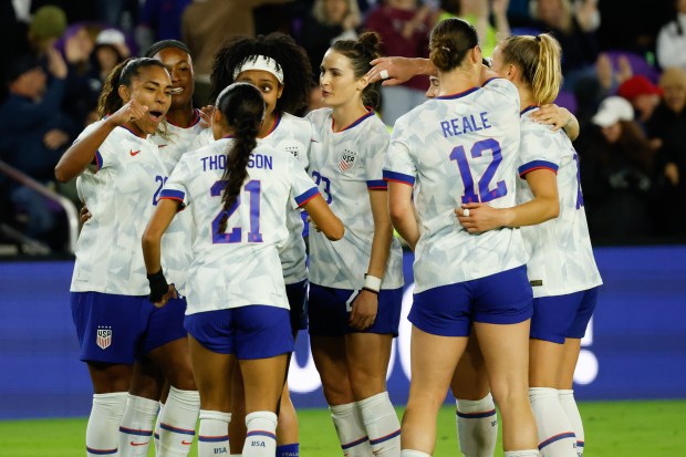 Members of the US Women's National Team gather to celebrate...