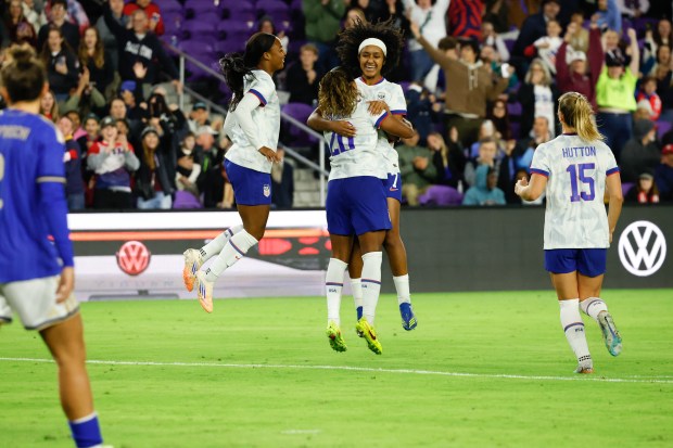 US Women's National Team midfielder Lily Yohannes jumps and hugs...