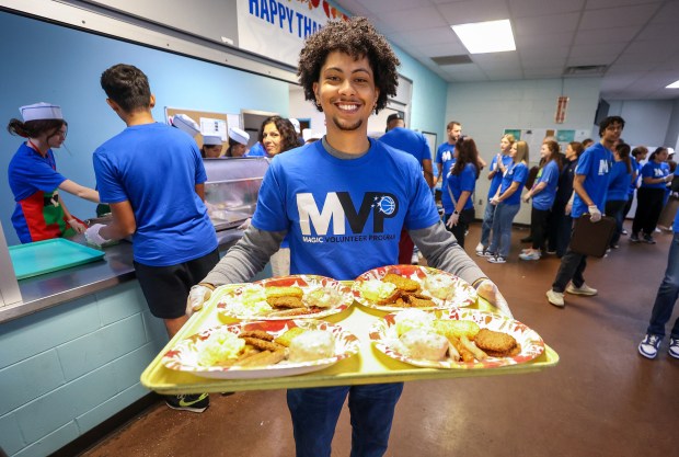 A THANKSGIVING TRADITION — Volunteer Alonzo Parker is ready to...