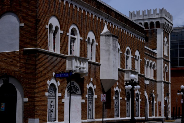 Exterior of The Castle nightclub in Ybor City, a historic brick building with white trim, arched windows, small balconies, and a crenellated tower reminiscent of a fortress.