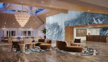 The renovated lobby at Saddlebrook Resort with a large chandelier, modern seating and a blue textured feature wall.