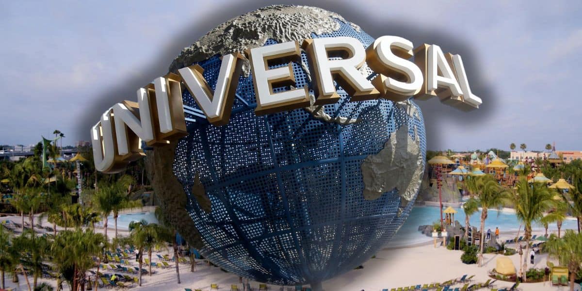 Iconic universal studios globe with a backdrop of Volcano Bay, a tropical resort.