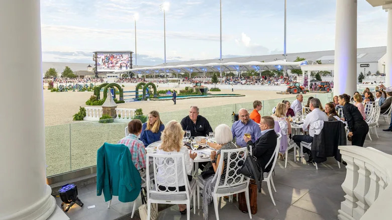 Visitors at World Equestrian Center dine on a pretty arena-side patio at the Grand Prix horse show