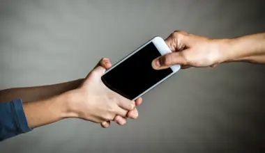 Stock image of hands fighting for a mobile device