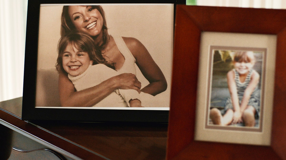 A photo of Eva LaRue holding her young daughter.