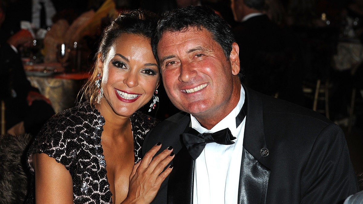 Eva LaRue posing next to then-husband Joe Cappuccio at an elegant dinner.