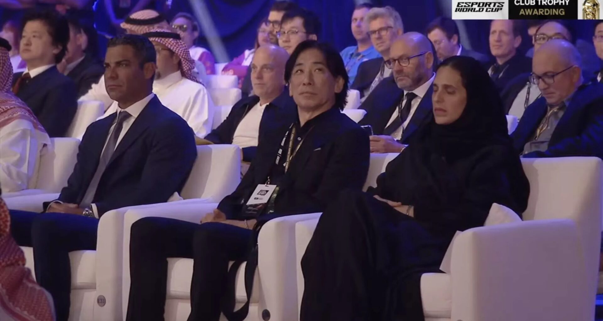 dignitaries in comfy white armchairs at a fancy ceremony