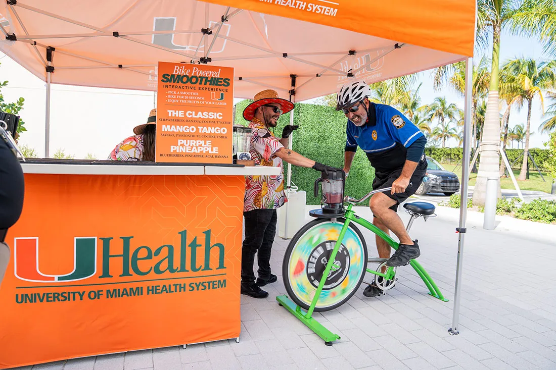 An attendee at the UHealth SoLé Mia community event rides the exercise bike