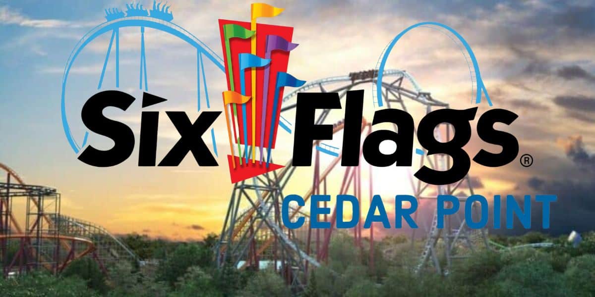 A vibrant image showcasing roller coasters at sunset with the "Six Flags" and "Cedar Point" logos prominently displayed in the foreground, indicating a collaboration or combination of the two well-known amusement parks. A scenic sky and coaster silhouettes enhance the background.