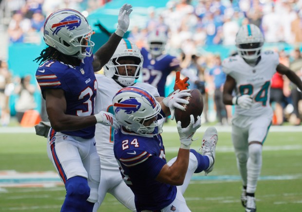Buffalo Bills safety Cole Bishop intercepts a pass intended for...