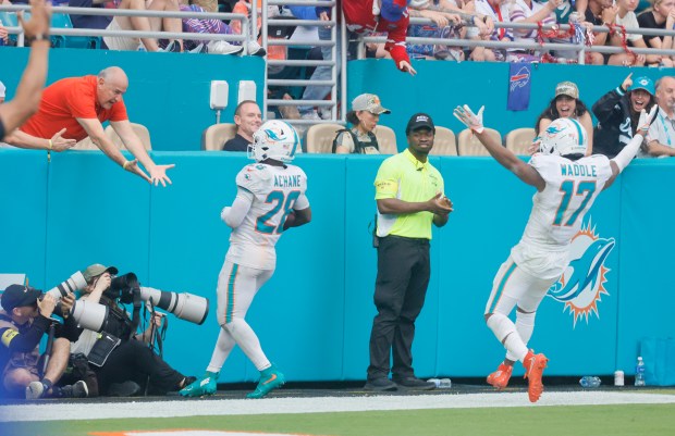 Miami Dolphins running back De'Von Achane runs in a touchdown...