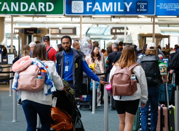 A TSA officer assists passengers at the security checkpoint at Orlando International Airport on Friday, Nov. 7, 2025. (Rich Pope/Orlando Sentinel