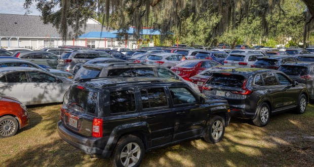 Cars are lined up before the distribution begins Food giveaway for 350 families at Friends Community Church on Dean Road in Orlando, hosted by Maxwell Frost, Orange County Commissioner Maribel Cordero, and Second Harvest Food Bank, on Friday, Nov. 7, 2025. (Ricardo Ramirez Buxeda/Orlando Sentinel)