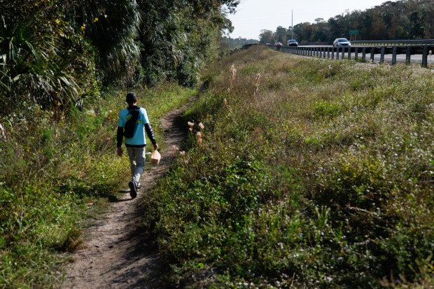 Richie Amabile from United Global Outreach heads into a wooded...