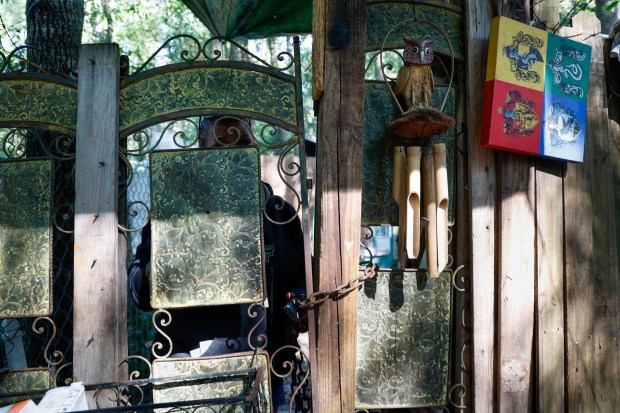 Stacey, at the front gate of a homeless encampment in...