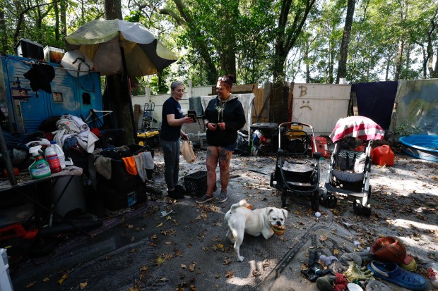 Lauren Tucker speaks with Stacey, a homeless individual who lives...