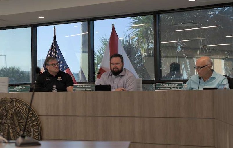 three people sitting at the dais at the april 1 treasure island commission meeting.