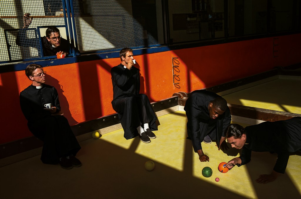 An Alex Webb photograph from Lavazza's 2026 calendar showing a priests drinking coffee while playing bocce ball.
