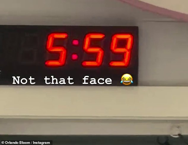 Orlando captioned the clip 'not that face' with a laughing emoji and then zoomed into a digital clock that showed it was 5:59am