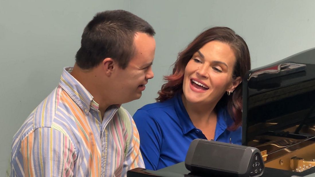 Music therapist Tamela Ponder sings with client Matthew Saul at Joyful Music Therapy in Orlando. (Spectrum News/Jeff Allen)