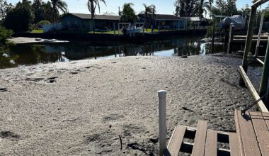 Riviera Bay residents, like Kathy Crow, say all their canals are full of sand and sediment. (Spectrum News/Josh Rojas)
