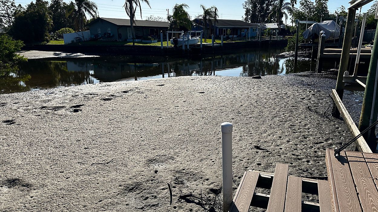 Riviera Bay residents, like Kathy Crow, say all their canals are full of sand and sediment. (Spectrum News/Josh Rojas)