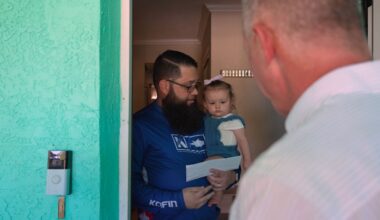 Christian Piccion receives a check to help with recovery from the recent hurricanes. The program is called People First. (Pinellas County photo)