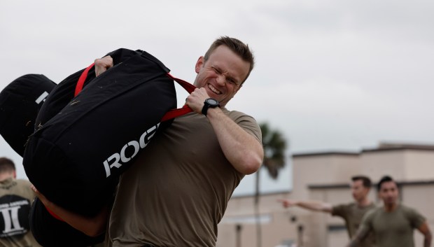 Capt. Alex Colla of SD12, lifts a sandworm with his team during the first day of events for the Space Force Guardian Arena at Patrick SFB, on Monday, December 8, 2025. Capt. Colla was part of the team that won the first Guardian Arena competition. (Ricardo Ramirez Buxeda/Orlando Sentinel)