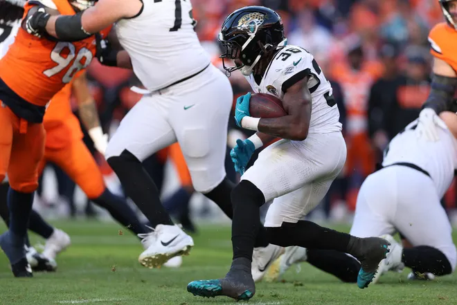 DENVER, COLORADO - DECEMBER 21: Lequint Allen Jr. #36 of the Jacksonville Jaguars runs with the ball during the second quarter against the Denver Broncos at Empower Field At Mile High on December 21, 2025 in Denver, Colorado. (Photo by Matthew Stockman/Getty Images)