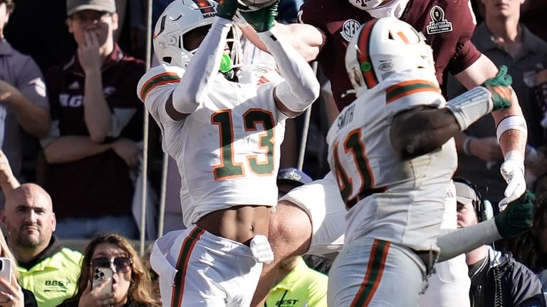 Miami defensive back Bryce Fitzgerald (13) intercepts a pass in...