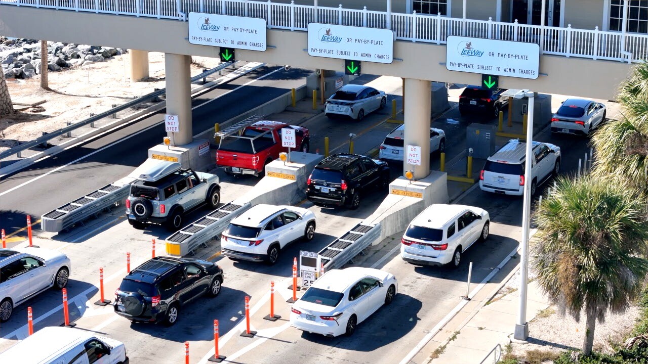 Cars rolling through Sanibel toll plaza