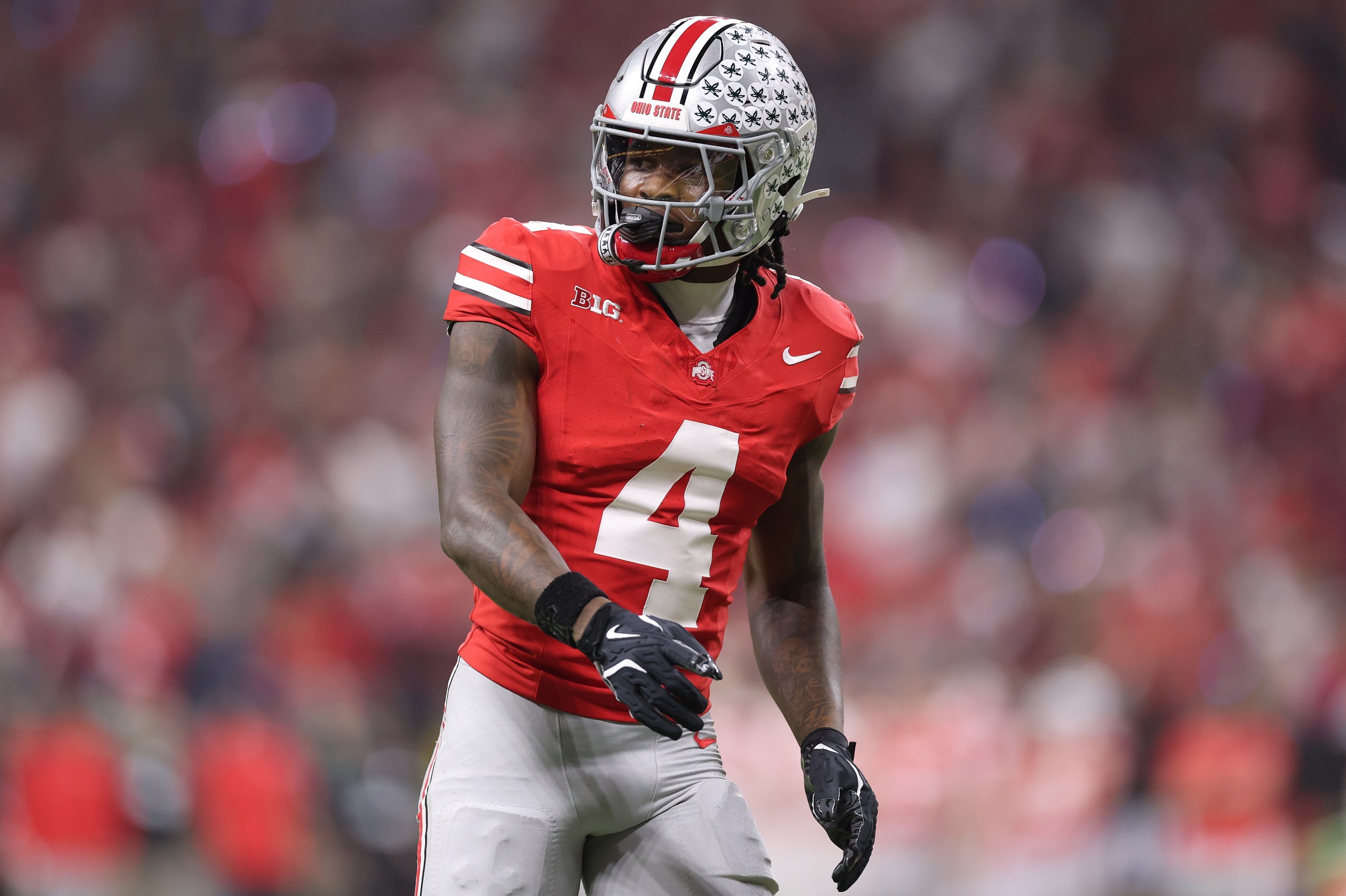INDIANAPOLIS, INDIANA - DECEMBER 06: Jeremiah Smith #4 of the Ohio State Buckeyes in action against the Indiana Hoosiers in the 2025 Big Ten Football Championship at Lucas Oil Stadium on December 06, 2025 in Indianapolis, Indiana. (Photo by Michael Reaves/Getty Images)