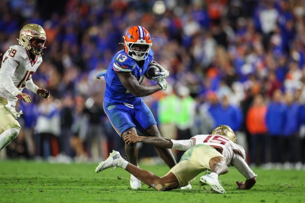 Florida sophomore tailback Jadan Baugh (13) rushed for 266 yards against Florida State Nov. 29 in the Swamp to become the Gators' first 1,000-yard rusher during the regular season since 2012. (Photo by James Gilbert/Getty Images)