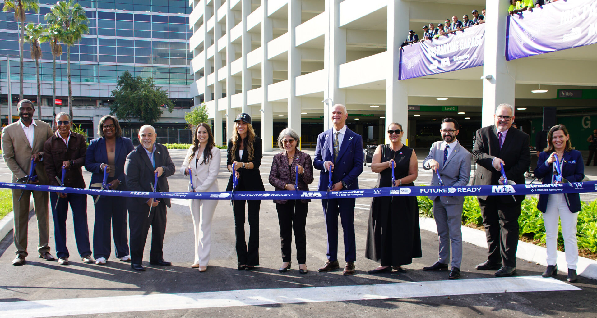 Miami-Dade County Mayor Daniella Levine Cava (center), Miami-Dade County Chief Operations Officer Jimmy Morales and County Commissioners Natalie Milian-Orbis and Danielle Cohen Higgins (left of center), MIA Director and CEO Ralph Cuti&eacute;, Lemartec Senior Vice President Maira Suarez, and Florida State Rep. Juan Carlos Porras (right of center), and other local and MIA officials cut the ribbon for the new Ibis Garage.